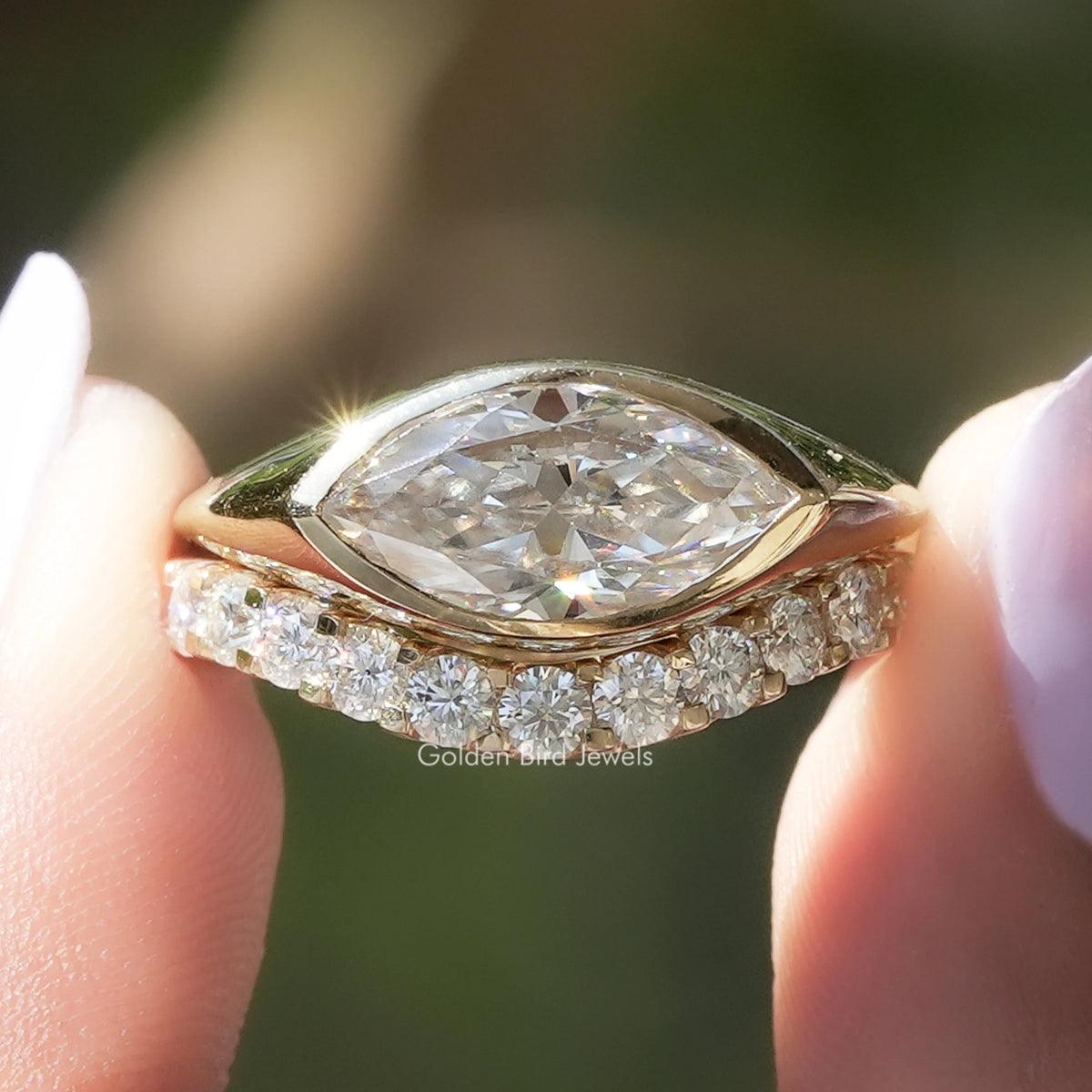 Gold-tone bridal ring set with marquise center stone and round halo side stones