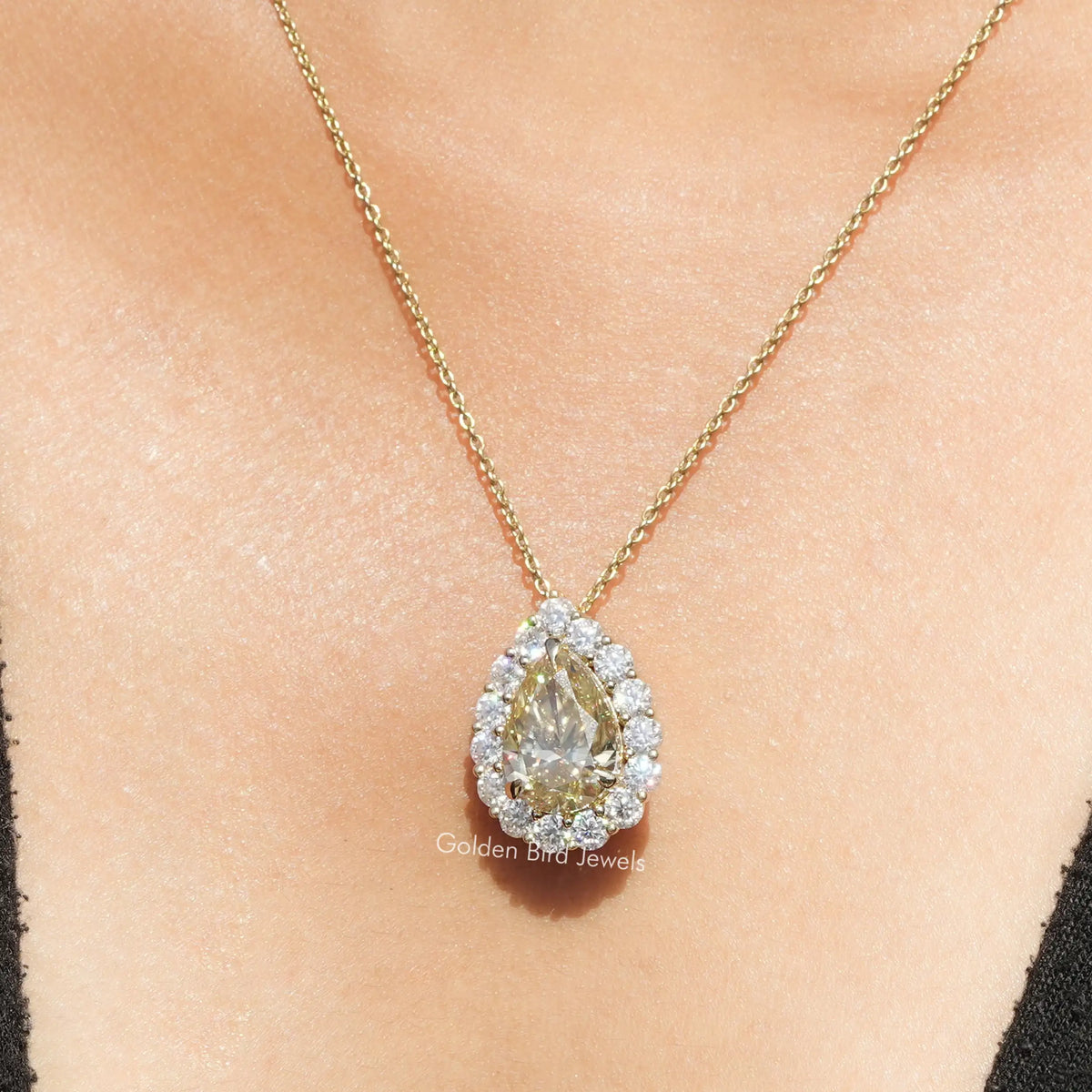 Gold-tone pear moissanite halo pendant necklace with teardrop center and round crystals