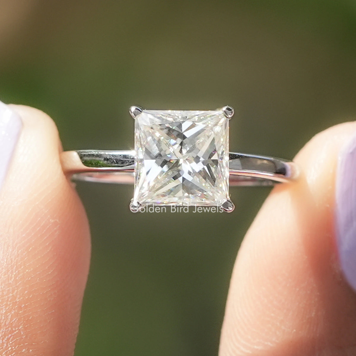 Princess-cut moissanite solitaire engagement ring in silver with four-prong setting