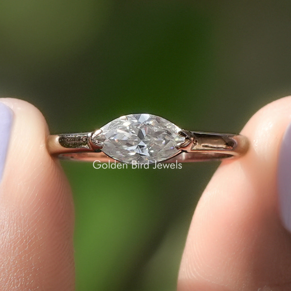Marquise-cut solitaire ring with clear stone and gold-tone prongs