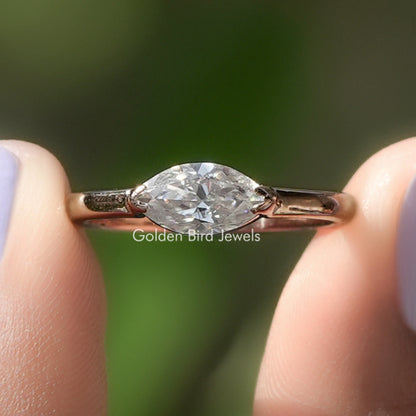 Marquise-cut solitaire ring with clear stone and gold-tone prongs
