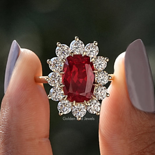 Red cushion ruby halo engagement ring with diamond accents on sterling silver band