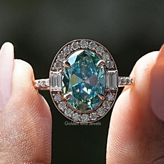 Oval blue moissanite halo ring with round and baguette stones