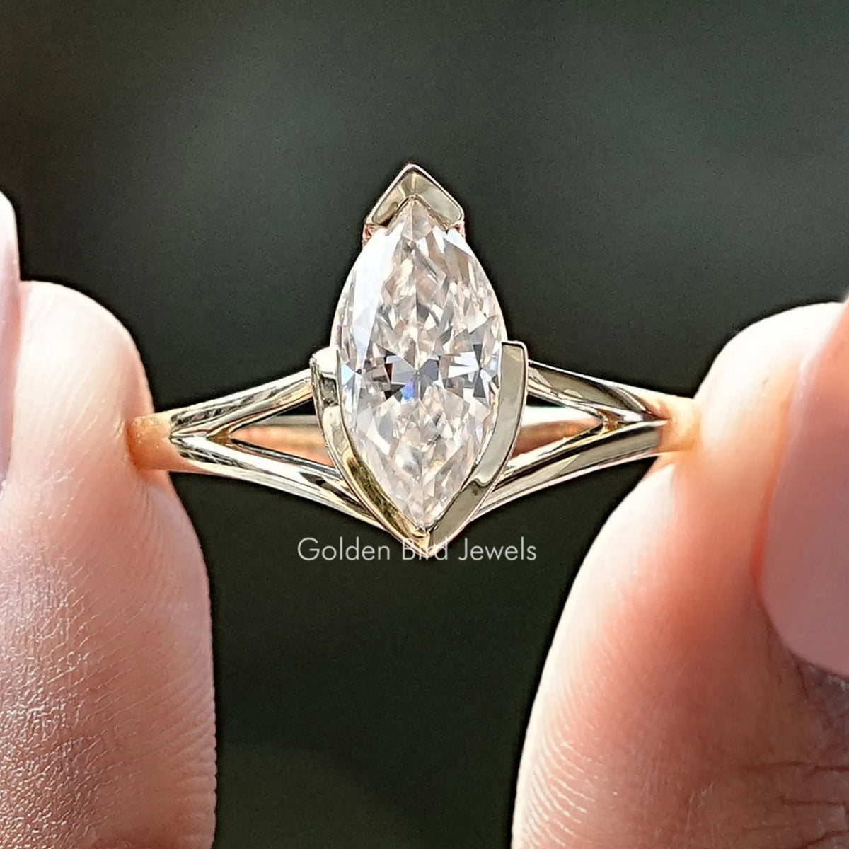 Gold-tone split shank moissanite ring with marquise center stone