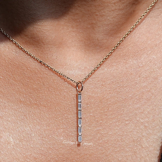 Gold-tone vertical bar pendant with baguette moissanite stones on a delicate chain
