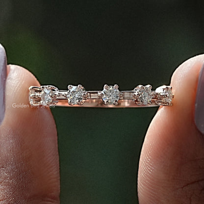 Half eternity ring with round moissanite stones across the top, metal band