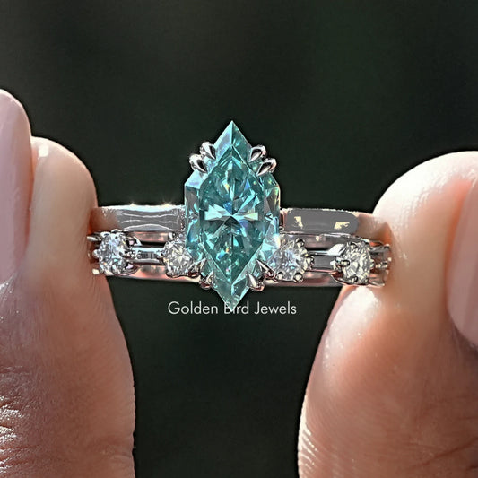 Blue marquise-cut bridal ring set with center stone and side baguette accents