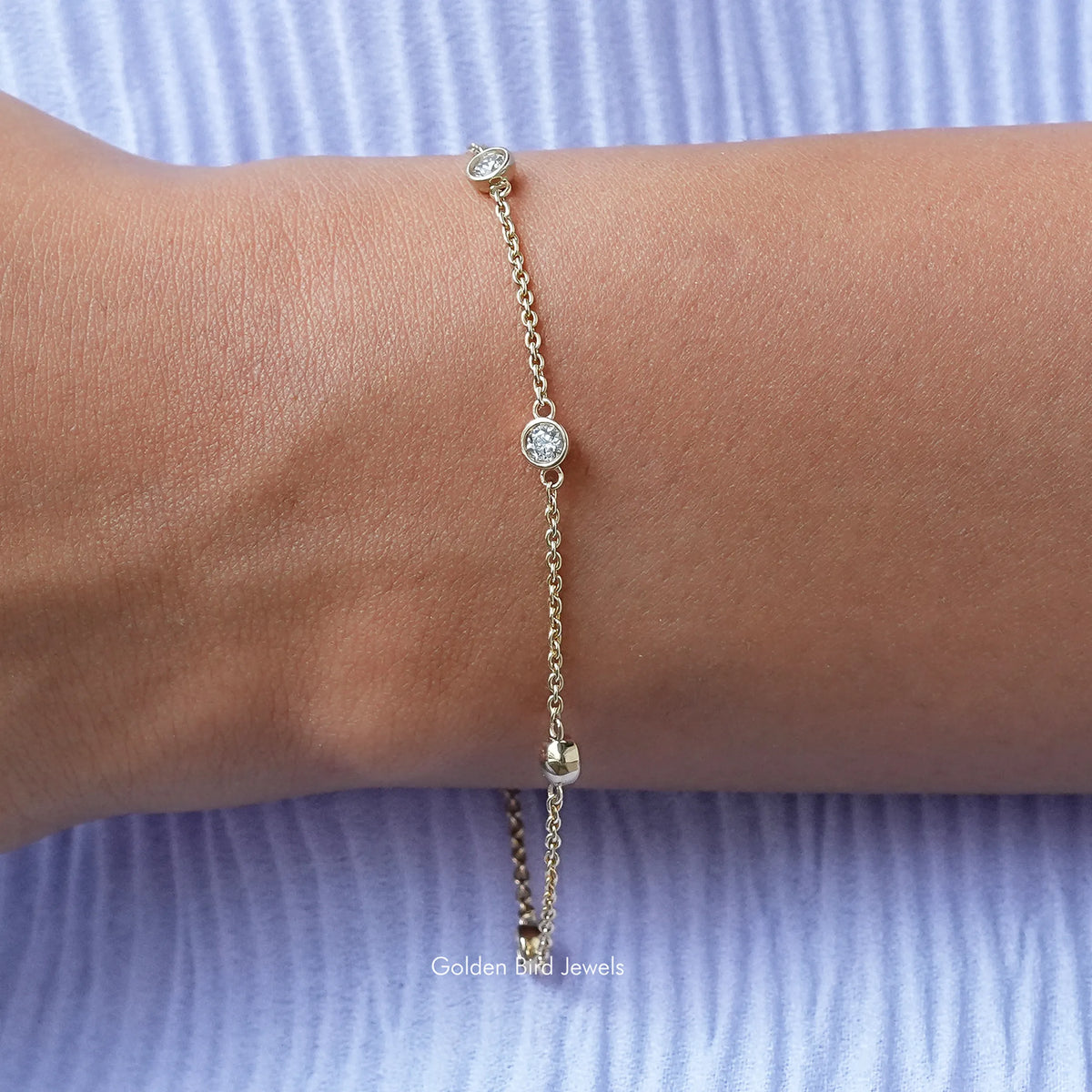 Gold-tone round bezel moissanite chain bracelet with small circular stones