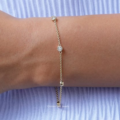 Gold-tone round bezel moissanite chain bracelet with small circular stones
