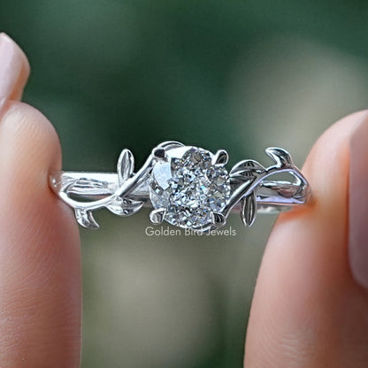 Portuguese Cut Round Diamond Engagement Ring Held Between Fingers