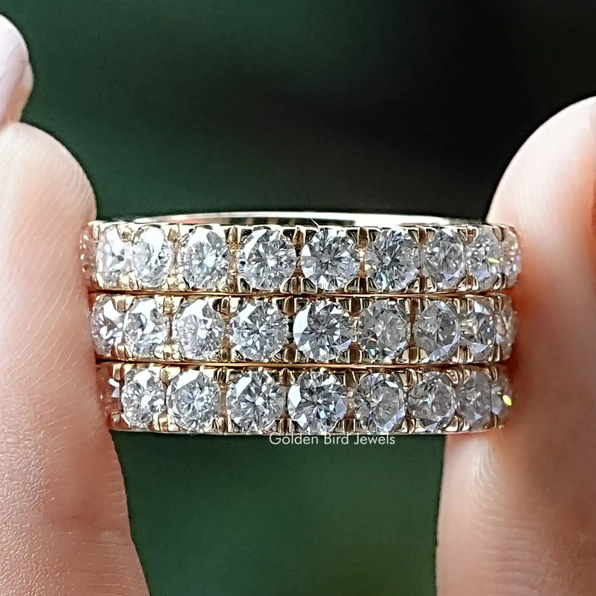 Round-cut moissanite eternity band with clear round stones on a silver band