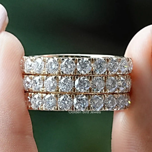 Round-cut moissanite eternity band with clear round stones on a silver band