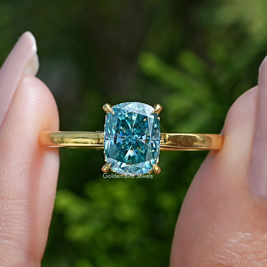 Gold engagement ring with elongated cushion-cut blue moissanite center stone