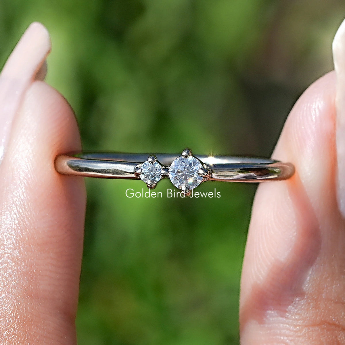 Round Cut Lab Diamond Toi Et Moi Ring Held Between Fingers