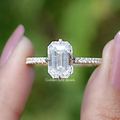 Emerald-cut moissanite engagement ring with hidden halo, baguette side stones, prong setting