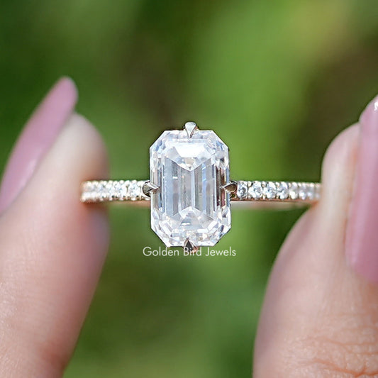 Emerald-cut moissanite engagement ring with hidden halo, baguette side stones, prong setting