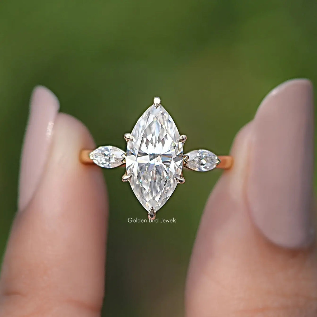 Gold-tone three-stone marquise moissanite ring with round side stones