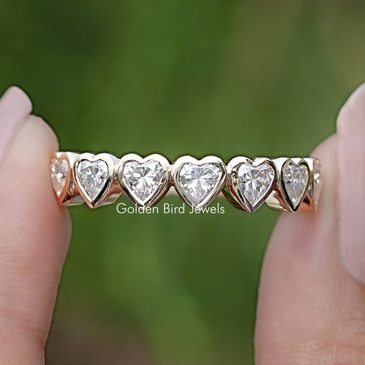 Heart-shaped eternity band with bezel-set hearts, close-up row of stones