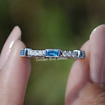 Sterling silver eternity band with blue baguette gemstone accents