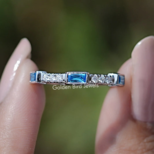 Sterling silver eternity band with blue baguette gemstone accents