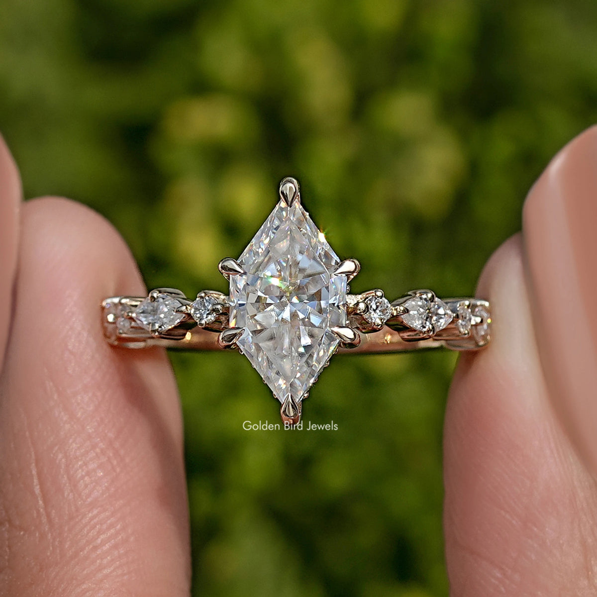 Gold-tone marquise moissanite ring with round side stones and bright center stone