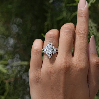 Marquise moissanite halo ring with split shank accents, worn on hand