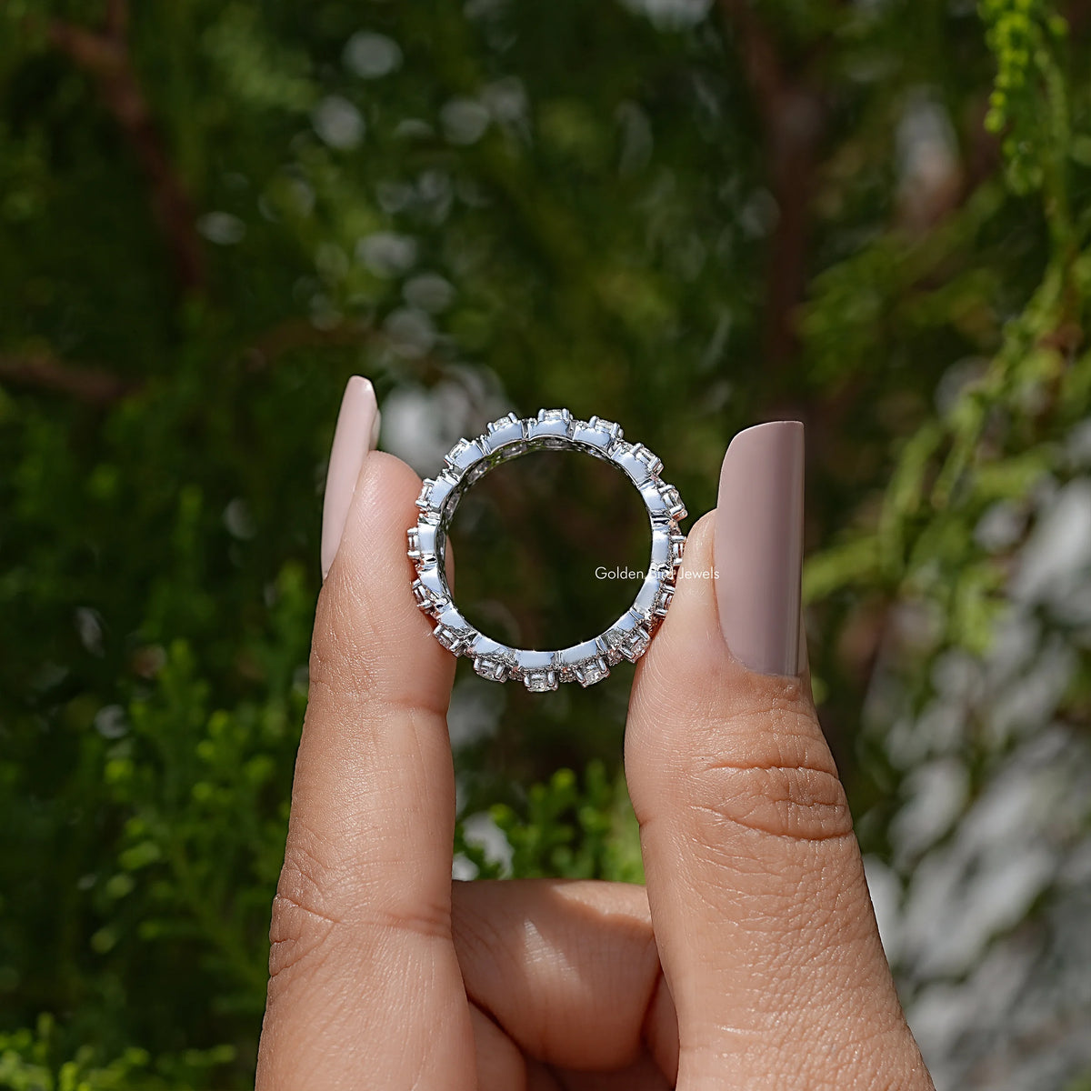 Silver-toned round halo ring with a circular frame of small sparkling stones