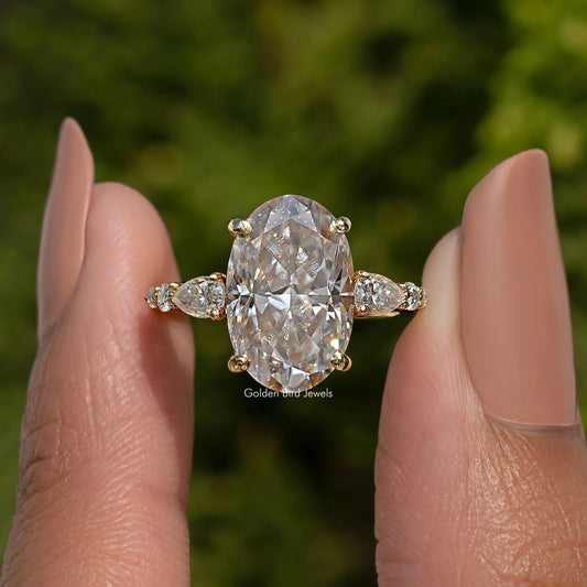 Oval moissanite cluster engagement ring close-up with large center stone and side marquises