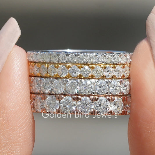 Stacked full eternity moissanite matching bands with round cut stones, shiny silver