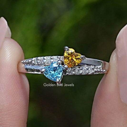 Heart-shaped gemstone accent ring with blue and yellow stones on silver band