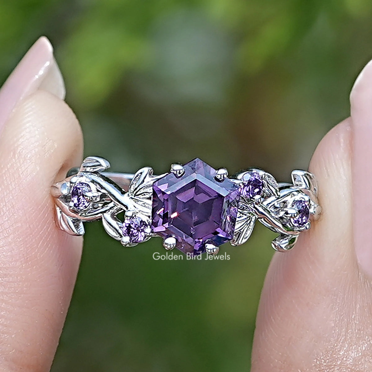 Purple amethyst hexagon cut engagement ring with silver leaf and floral side accents
