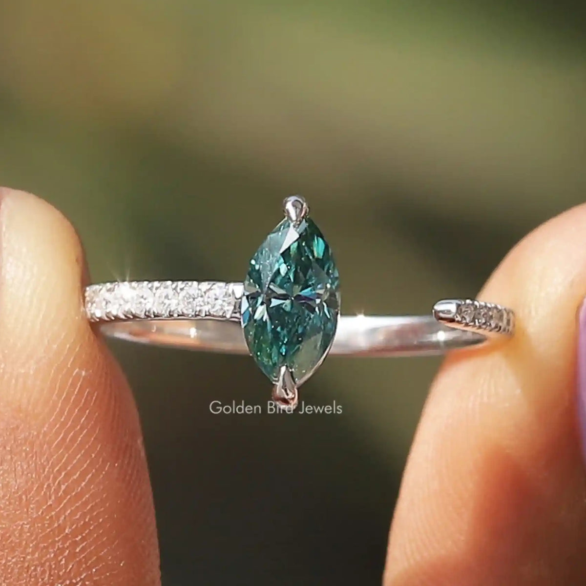 Marquise cut moissanite open cuff ring with pavé accents on a slender silver band
