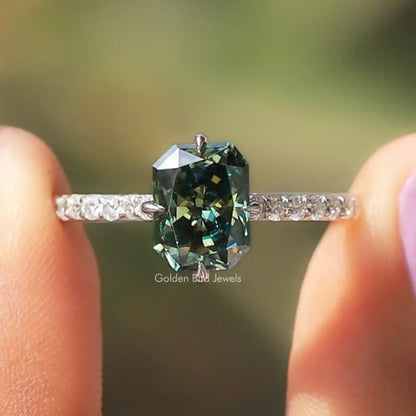 Sterling silver moissanite ring with green radiant cut center stone and pave band