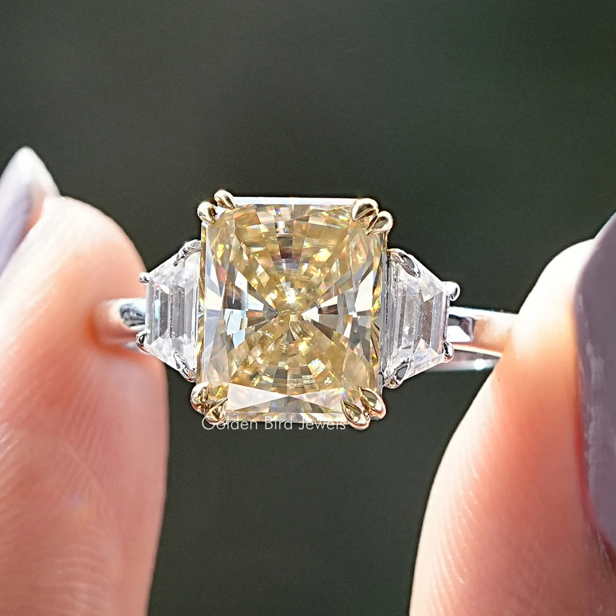 Three-stone yellow radiant moissanite ring with square center and baguette side stones