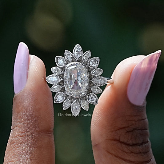 Sterling silver ring with oval cushion moissanite and leaf-style halo cluster