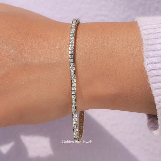 Half-bezel tennis bracelet with princess-cut clear stones on slim silver band