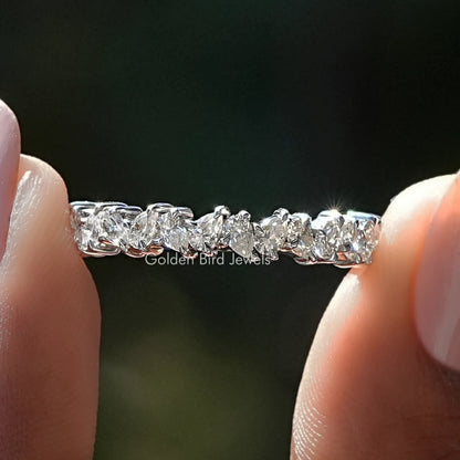 Silver half eternity band with clear pear-cut moissanite stones, close-up view