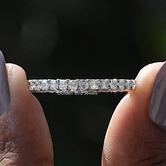 Moissanite eternity wedding band ring with channel-set square stones, silver tone.