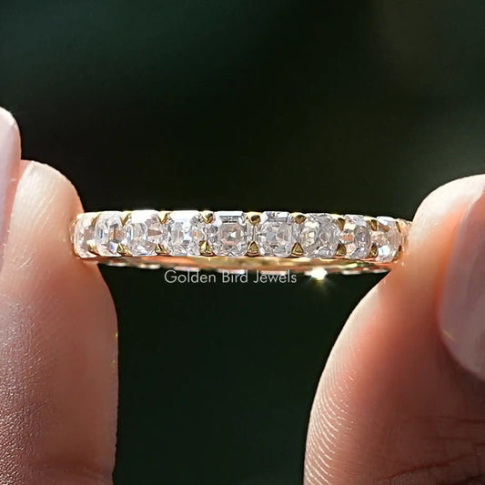 Silver-tone eternity band close-up showing square-cut moissanite stones