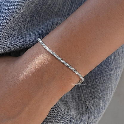 Silver tennis bracelet angled on wrist, row of asscher-cut moissanite stones