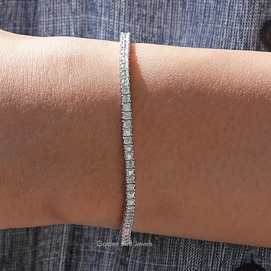 Silver tennis bracelet with small asscher-cut moissanite stones in a line