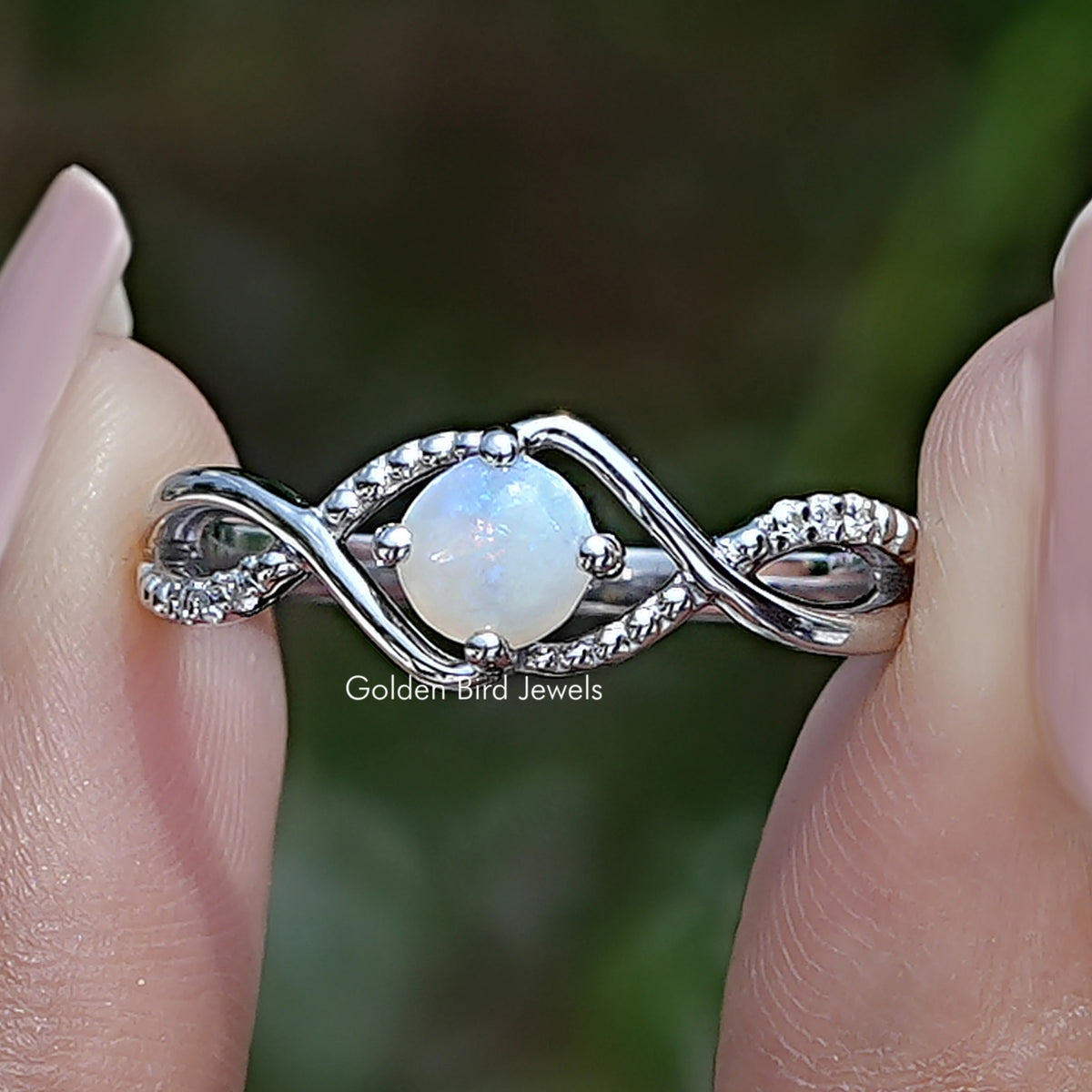 Opal round infinity accent ring with prong-set opal and small clear stones