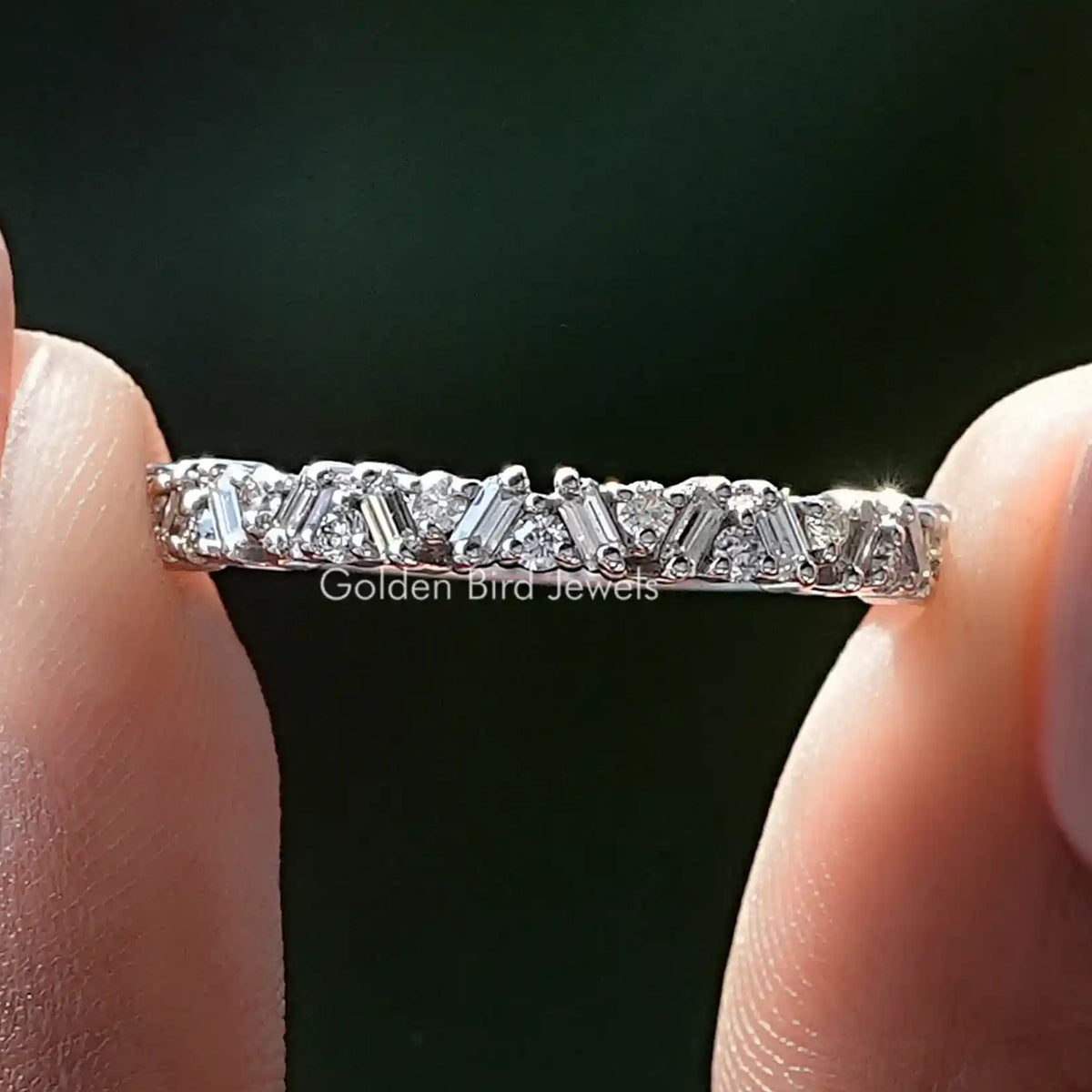 Close-up of silver half eternity band with round and baguette lab diamonds