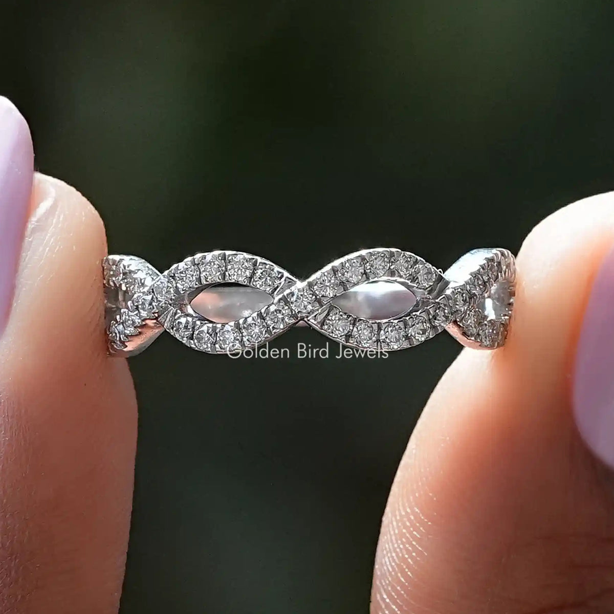 Moissanite infinity eternity band with pavé-set interlocking loops