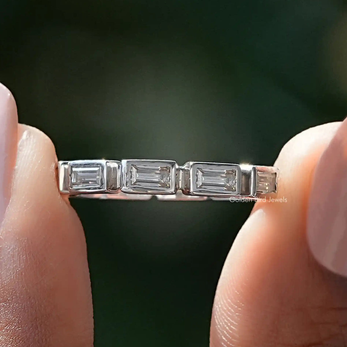 Silver eternity band with baguette-cut rectangular stones, close-up
