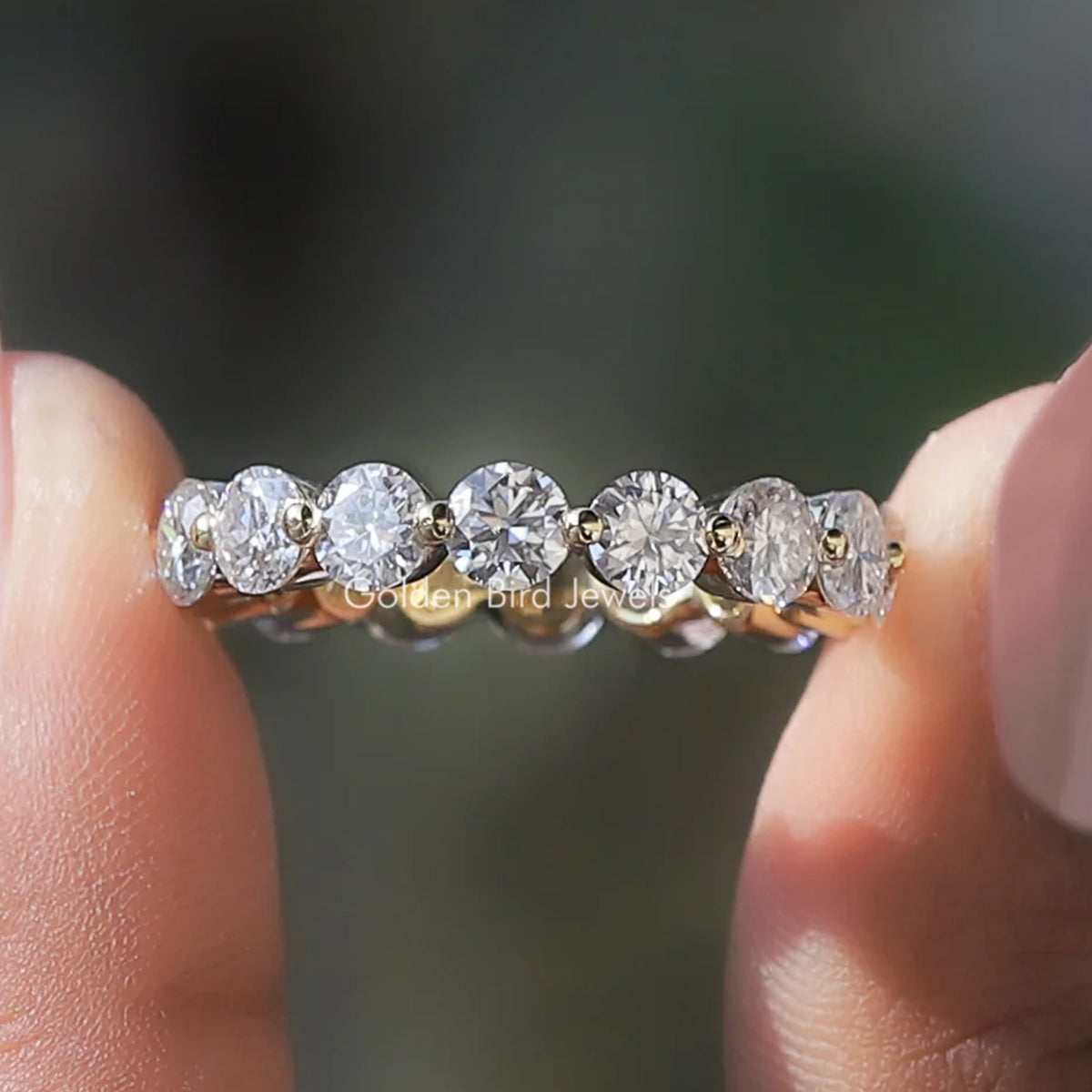Full eternity wedding band with round-cut clear stones in a row, close-up