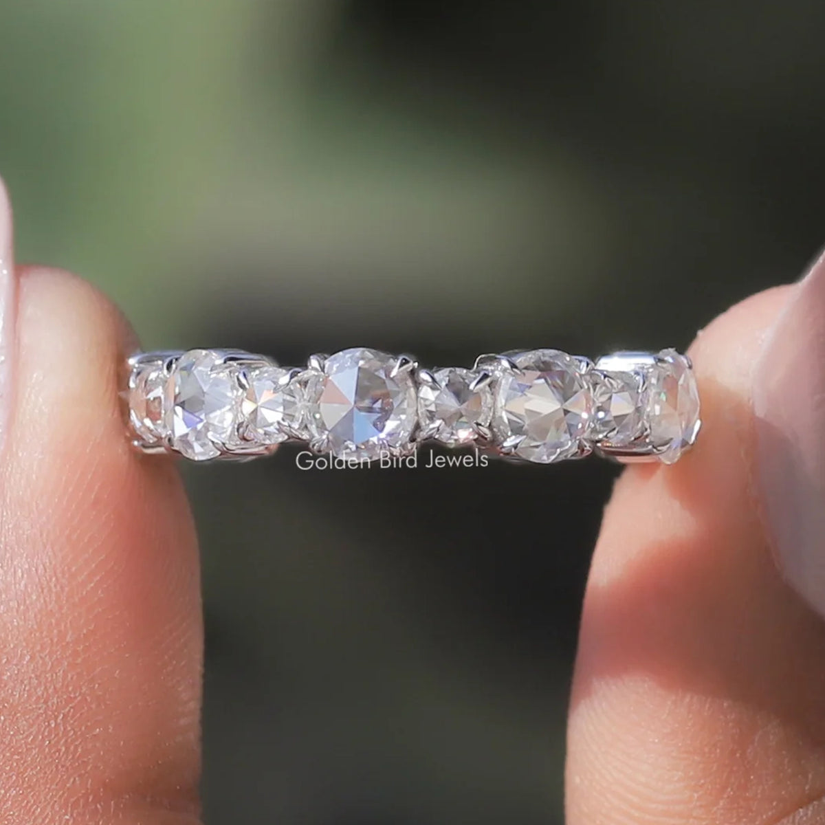 Round moissanite eternity band ring with clear stones in silver setting