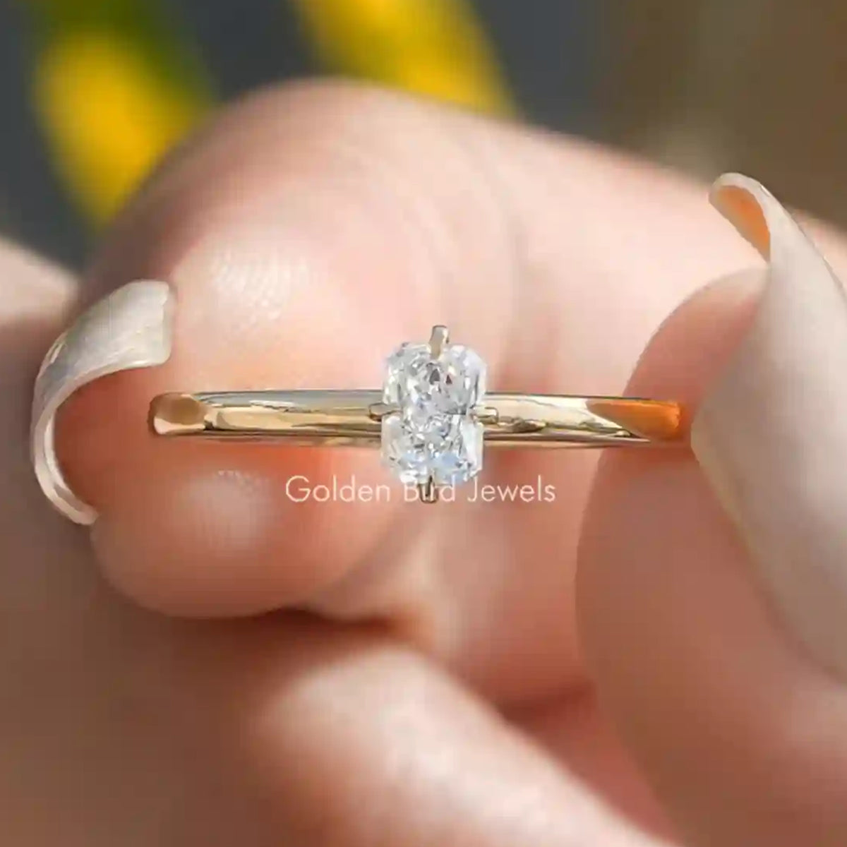 Gold solitaire proposal ring with raised center gemstone in four-prong setting