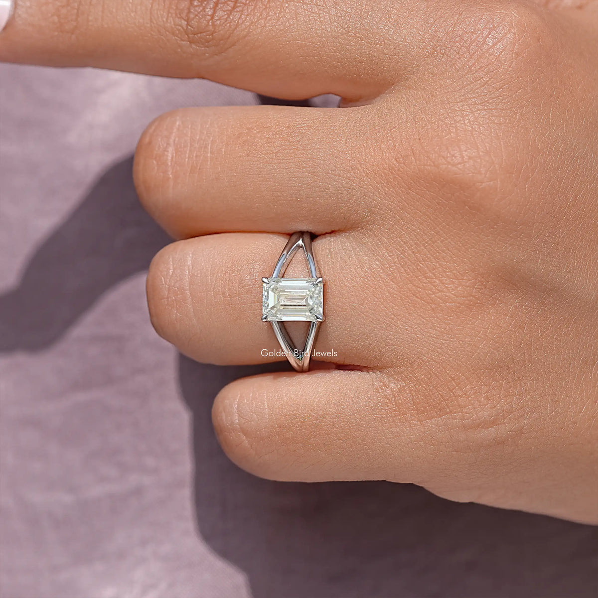 Sterling silver emerald-cut ring with square prongs, close-up