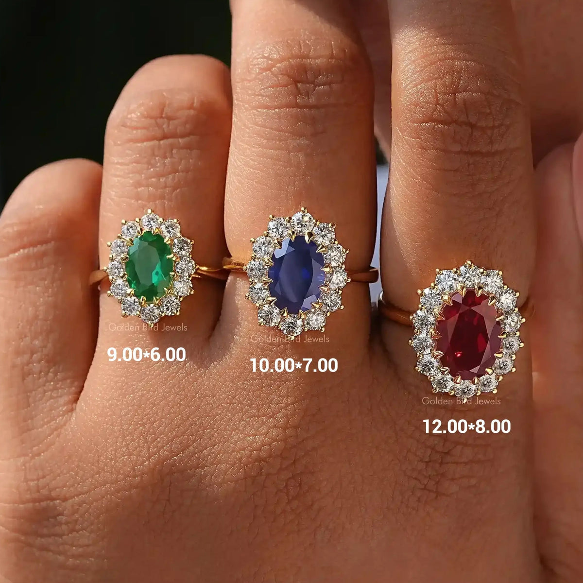 Oval cut gemstone halo engagement ring with three colored center stone on fingers